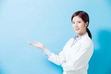 woman dentist show something on the blue background