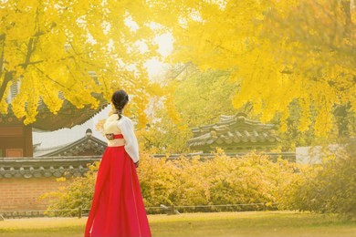 beautiful young woman in autumn at gyeongbokgung palace in seoul,south korea