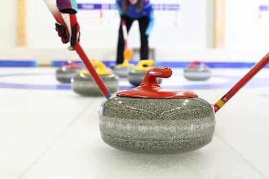 granite curling stones.curling on the ice. team curling game.
