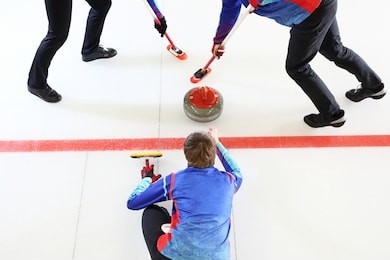 curling game. the player plays curling on the ice rink