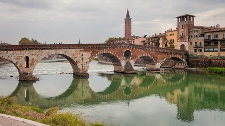 ponte pietra, a roman arch bridge crossing the adige river in verona, italy
