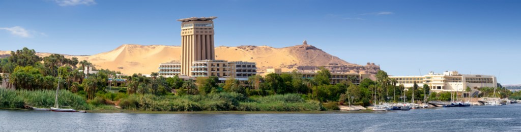 the nile at aswan and the west bank with tombs of the nobles (from the old and middle kingdom). there is qubbet el-hawa - 'dome of the winds' (tomb of a muslim prophet) at the crest of the hill