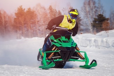 snowmobile races jump in snow. concept winter sports.