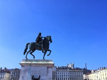 strolling around the place bellecour on the blue sky day in lyon, france