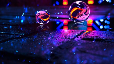 background of wet asphalt with neon light. reflection of neon lights in puddles, bright colors, glass ball. neon night city