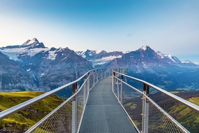 morning panorama view. popular tourist attraction skywalk at the first station.  location place swiss alps, grindelwald valley, europe.