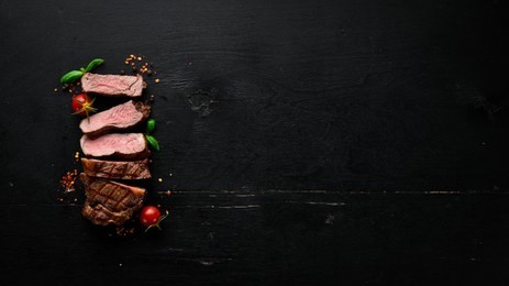 beef steak. veal, meat. on a black wooden background. top view. free copy space.