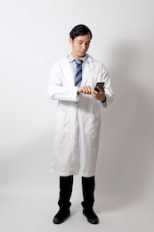 the asian doctor standing on the white background.