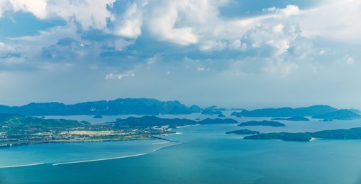 view of blue sky, sea and mountain seen from cable car viewpoint, langkawi, malaysia. picturesque landscape with tropical forest, beaches, small islands in waters of strait of malacca