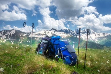 backpacks and mountain walking sticks in hiking trail. hiking in mountains concept. sport tourism