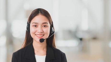 portrait of asian beautiful smiling woman customer support phone operator in office space banner background and copy space.concept call center job service.