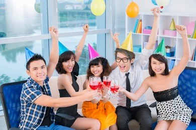 five friends clinking glasses with excitement