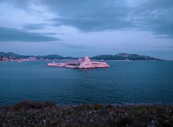 dark blue landscape with chateau d'if prison where alexander dumas imprisoned count monte cristo in his novel, marseille, france, view from iles de frioul.