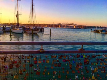 the bridge of love locks with a sunset backdrop at the harbour 