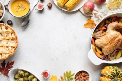thanksgiving dinner with chicken, apple pie, pumpkin soup brussel sprouts and fruits. traditional autumn food concept. flat lay. 
