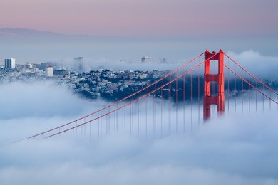golden gate at dawn surrounded by fog
