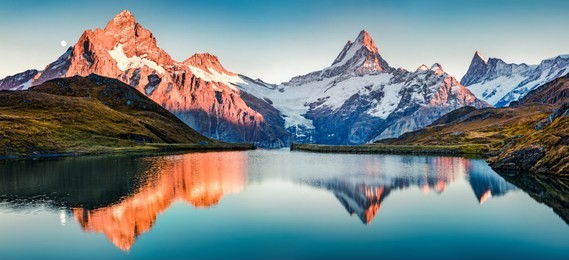fantastic evening panorama of bachalp lake / bachalpsee, switzerland. picturesque autumn sunset in swiss alps, grindelwald, bernese oberland, europe. beauty of nature concept background.
