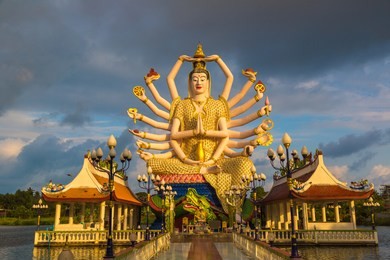 statue of shiva in wat plai laem temple, samui, thailand in a summer day