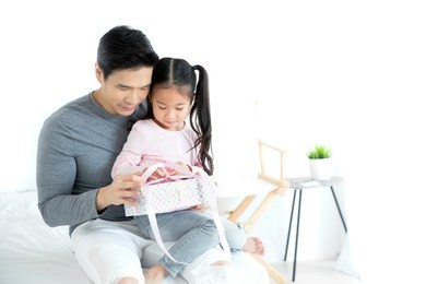 asian happy father's day concept, the daughter is giving gifts to her father.