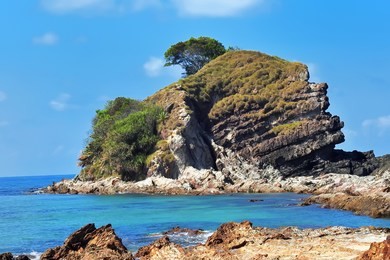   scenic sea view of the kapas island (cotton island) at terengganu, malaysia. clear sea water and blue sky background. soft and grain effect.        