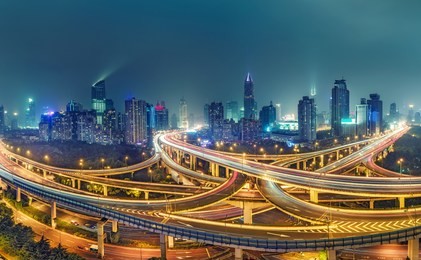 view on famous highway intersection in shanghai, china, with illuminated highways and skyscrapers. 