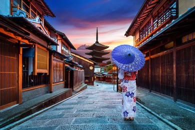 asian woman wearing japanese traditional kimono at yasaka pagoda and sannen zaka street in kyoto, japan.
