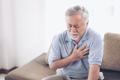 senior male asian suffering from bad pain in his chest heart attack at home - senior heart disease