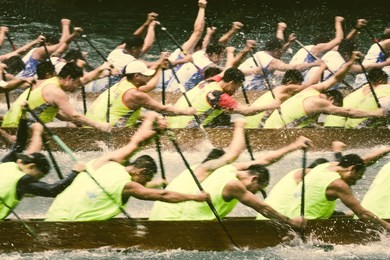 motion blur of dragon boats racing during dragon boat festival in hong kong