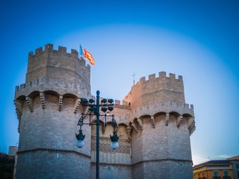 a photo of the exterior facade of the popular torres de serranos, which was one of the gates of the ancient of the city wall, christian wall, of valencia, in spain, europe. the photo was taken at dusk