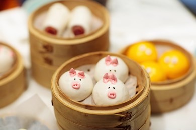 dim sum, traditional chinese dumpling in bamboo steamer, pig and animal theme for kids. street food for children in china, hong kong. family dinner with steamed dumplings.