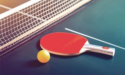 table tennis rackets and ball on table