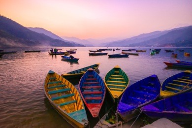 twilight with boats on phewa lake, pokhara, nepal