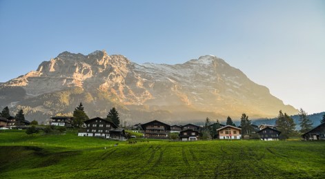 mountain village at sunset in grindelwald, switzerland. grindelwald was one of the first tourist resorts in europe.