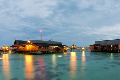 kapalai resort night view turquoise tropical polynesian paradise palm beach ocean sea crystal water borneo indonesia
