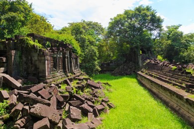 the hidden beauty of ancient temple ruins in the middle of jungle forest temple of beng mealea temple, siem reap, cambodia.