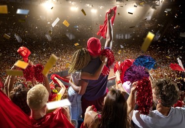 young sport supporter happy fans at basketball arena. beautiful black woman and man couple hugging and support the basketball team during the game