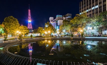the scenery of sapporo tv tower and odori park in spring , sapporo odori park is a park of rest and relaxation for citizens and tourists . each season there will be a variety of events at this park.