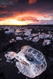 beautiful sunset over famous diamond beach near jokulsarlon lagoon, iceland, long exposure.