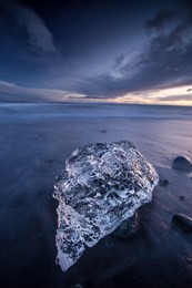 beautiful sunset over famous diamond beach near jokulsarlon lagoon, iceland, long exposure.