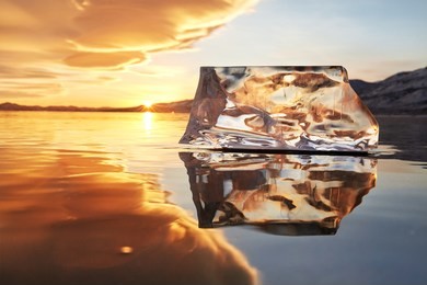 sunset sky and ice on lake baikal. winter ice on lake baikal. crystal clear drinking water. the floe on lake baikal broke away and is reflected in the ice as in a mirror.