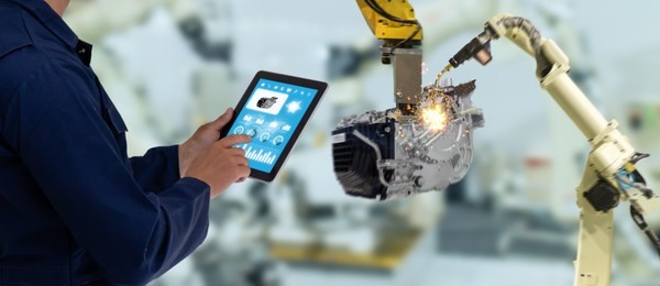 iot industry 4.0 concept,industrial engineer using software (augmented, virtual reality) in tablet to monitoring machine in real time.smart factory use automation robot arm in automotive manufacturing