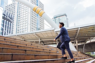 new gen young businessmen are stepping up their stairs to get in business with confidence in bangkok, thailand.