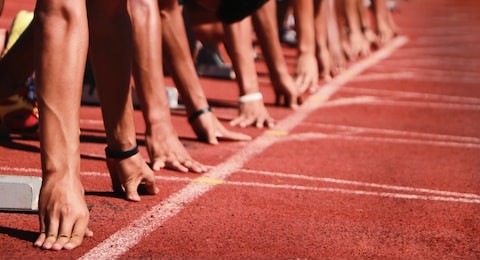 cropped image of a sprinter getting ready to start at the stadium