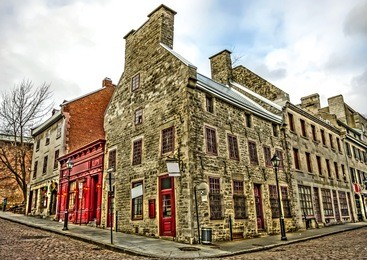 wide angle of corner street, and old architectural buildings in the heart of old montreal, hdr image. (with some digital noise)