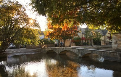 bourton-on-the-water in the autumn during the golden hour.