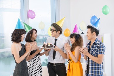 teen group of five celebrating the birthday of their friend