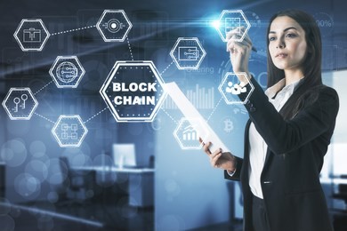 businesswoman with creative digital blockchain interface in blurry office interior. future and media concept. double exposure 