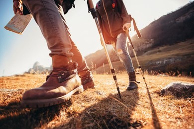 hiking man and woman with trekking boots on the trail
