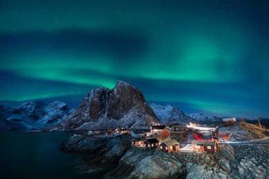 fisherman village with aurora in the background travel concept world explore northern light / lofoten norway