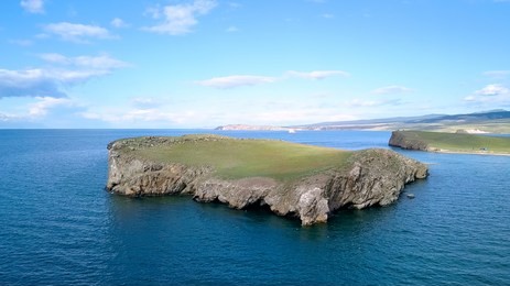 flight over land and water. russia, baikal, bay small sea. island kharantsy. near olkhon island, from drone  